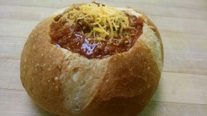 Hearty homemade chili in a delicious bread bowl at The Village Bakery